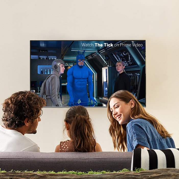 Family gathered around TV